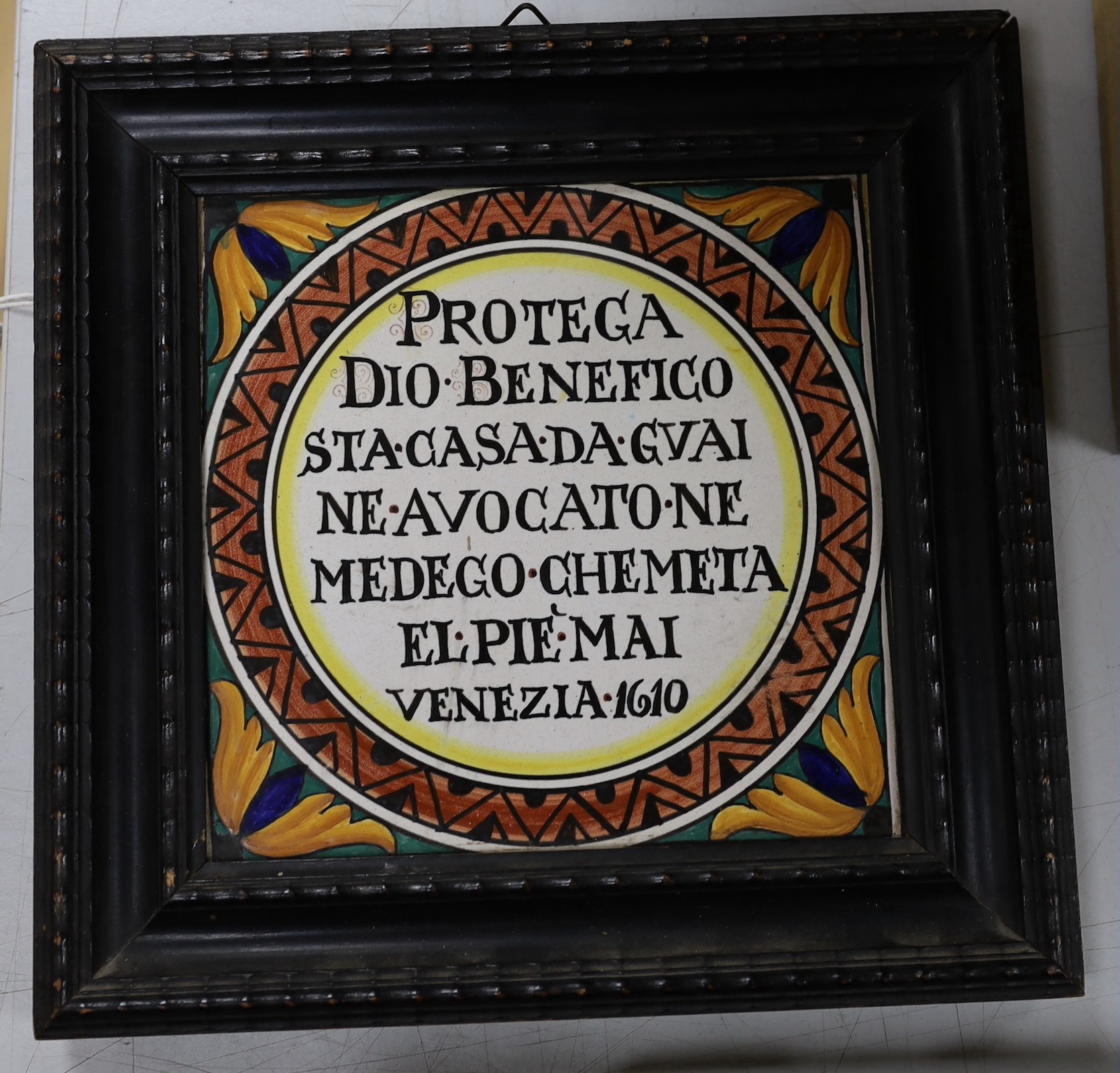 An Italian tile in hanging frame 27 x 27cm